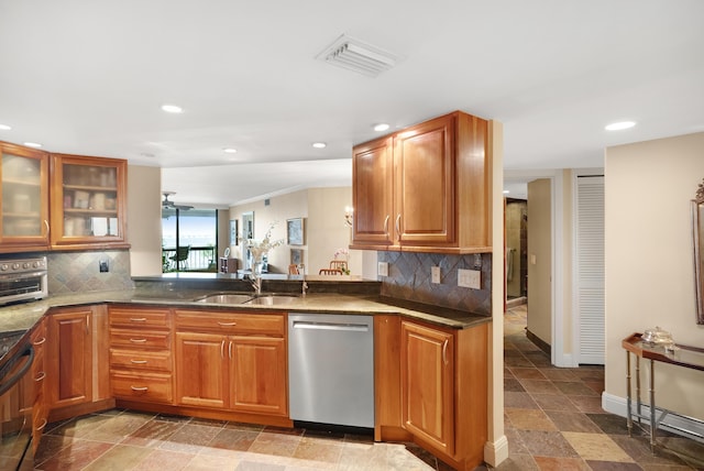 kitchen with dishwasher, kitchen peninsula, sink, and tasteful backsplash