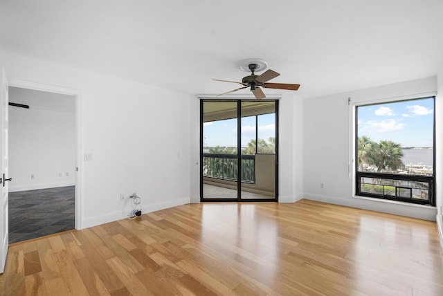 unfurnished room with light wood-type flooring and ceiling fan