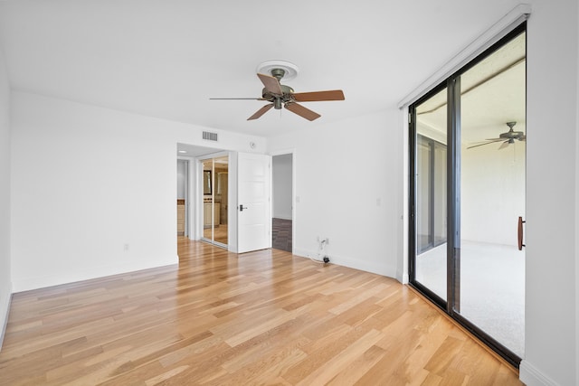 unfurnished bedroom with ceiling fan, access to exterior, and light wood-type flooring