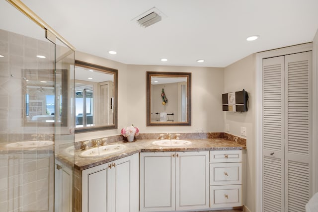 bathroom with vanity and a shower with shower door