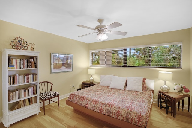 bedroom featuring multiple windows, light wood-type flooring, and ceiling fan