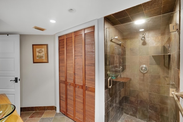 bathroom with tile patterned floors and a shower with door