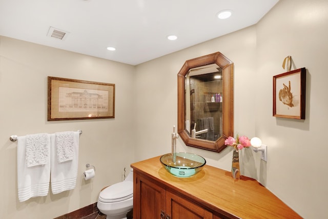 bathroom featuring vanity and toilet