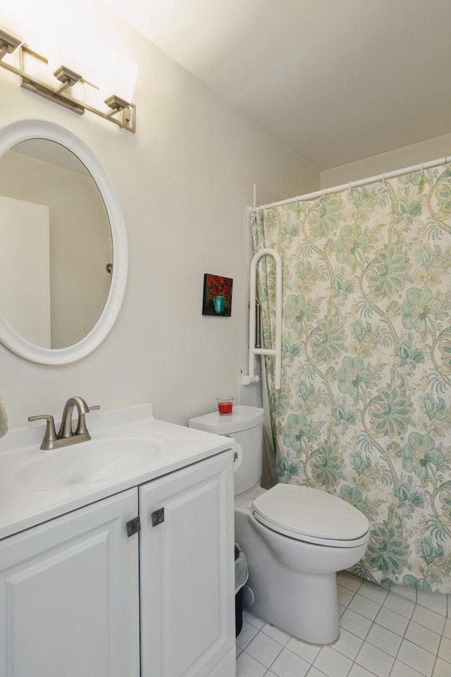 bathroom with tile patterned flooring, toilet, and vanity