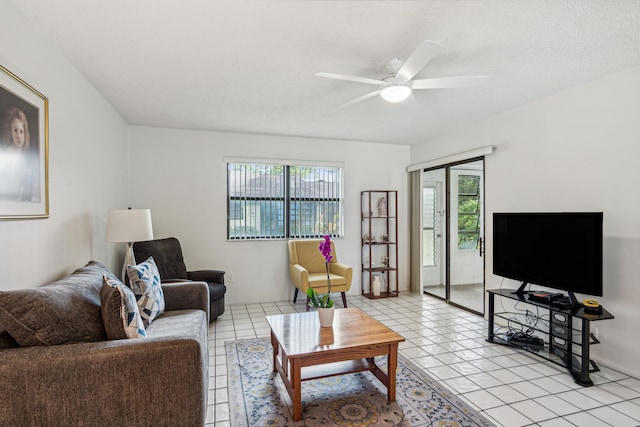 tiled living room featuring ceiling fan and a textured ceiling