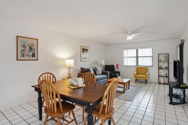 dining area featuring ceiling fan and light tile patterned floors