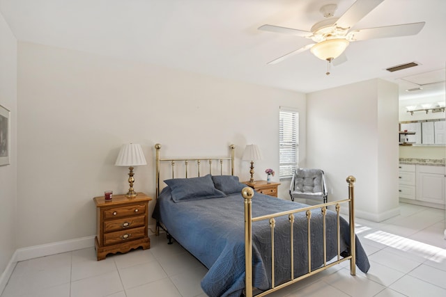 tiled bedroom with ceiling fan and ensuite bath