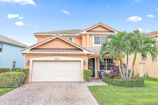 view of front of home with a garage and a front yard