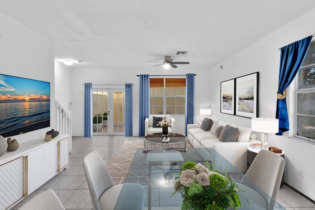 living room with ceiling fan, light tile patterned floors, and french doors