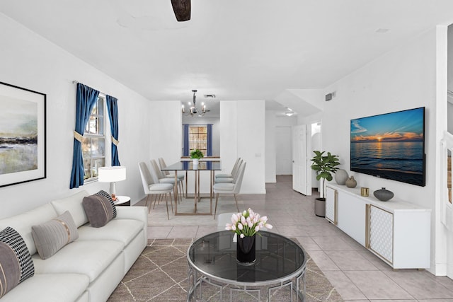 living room featuring a chandelier and light tile patterned floors