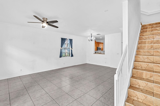 interior space with ceiling fan with notable chandelier and light tile patterned floors