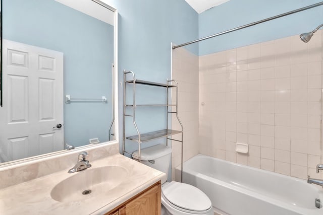 full bathroom featuring vanity, tiled shower / bath combo, and toilet