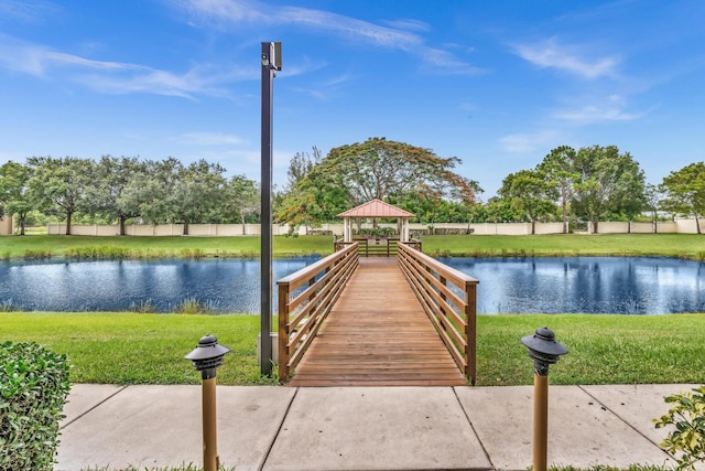 view of dock featuring a lawn, a gazebo, and a water view