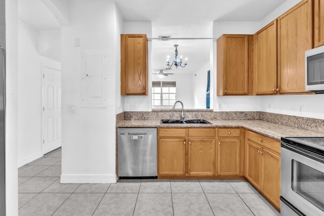 kitchen with stainless steel appliances, electric panel, sink, a notable chandelier, and light tile patterned flooring