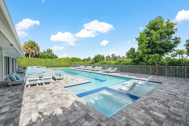 view of pool featuring an in ground hot tub and a patio