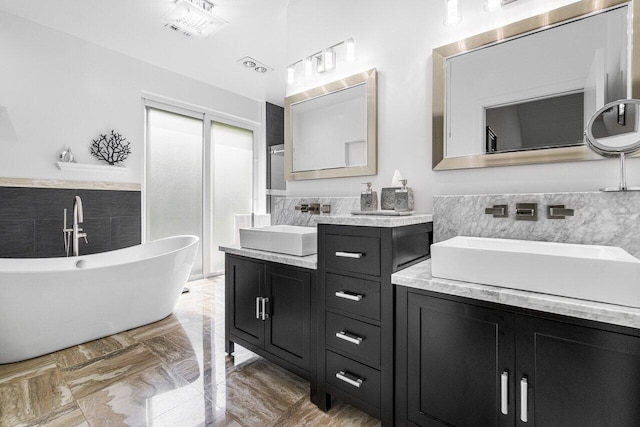 bathroom with vanity and a washtub