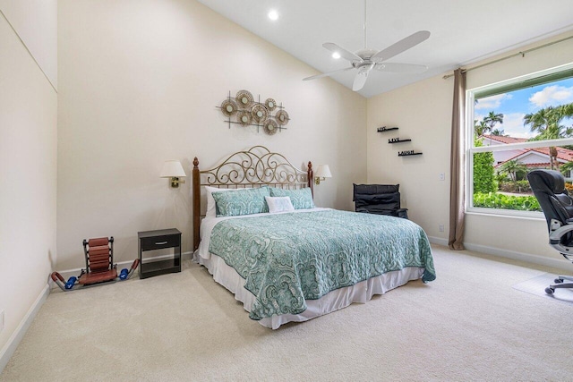 carpeted bedroom with ceiling fan and high vaulted ceiling