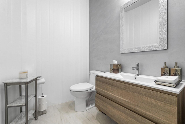 bathroom with hardwood / wood-style flooring, vanity, and toilet