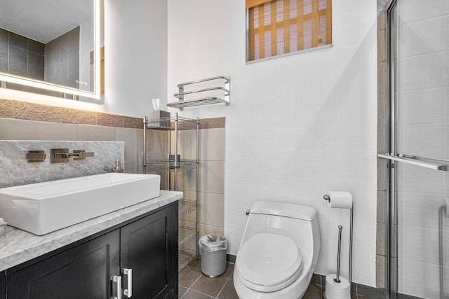 bathroom featuring walk in shower, tile walls, vanity, and toilet