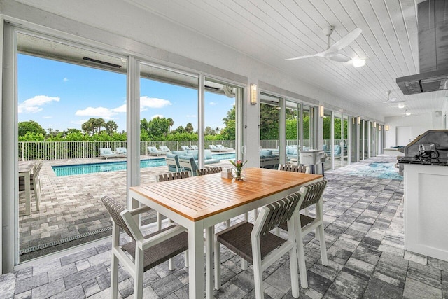 sunroom / solarium featuring wood ceiling and ceiling fan