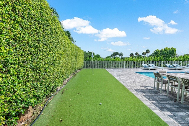 view of property's community with a swimming pool and a patio