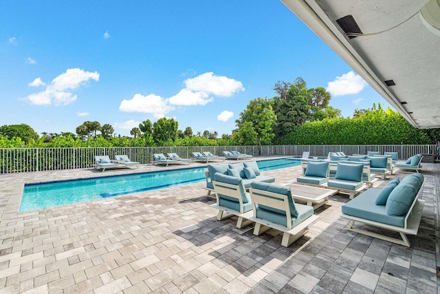 view of swimming pool featuring outdoor lounge area and a patio