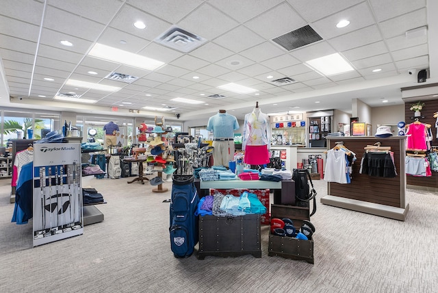 miscellaneous room with a drop ceiling and carpet flooring