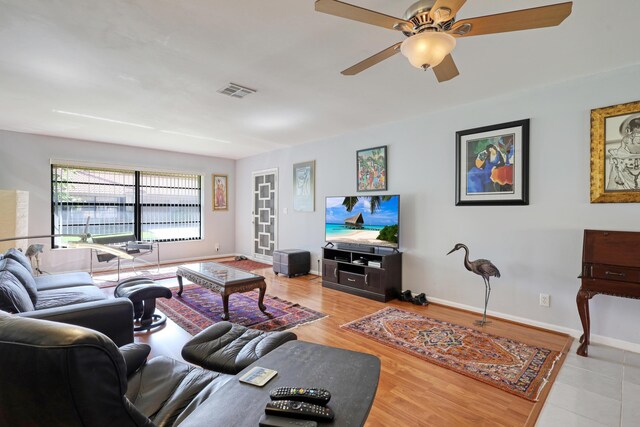 living room with ceiling fan and light wood-type flooring