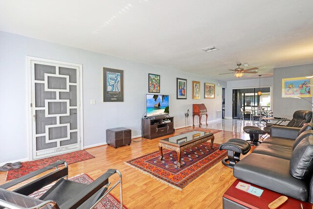 living room with ceiling fan and hardwood / wood-style flooring