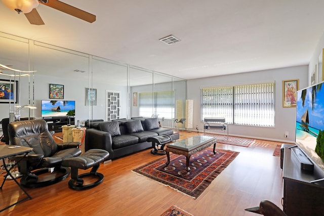 living room with ceiling fan and hardwood / wood-style flooring