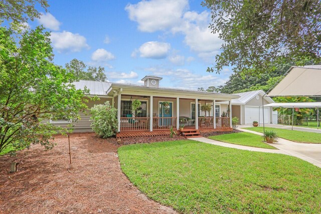 view of front of home featuring a garage, a porch, and a front yard