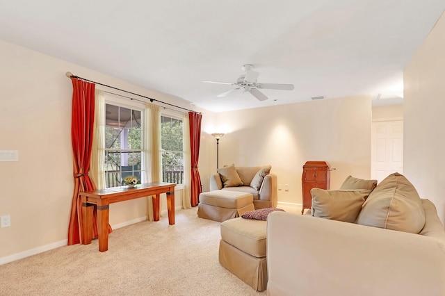 carpeted living room featuring ceiling fan