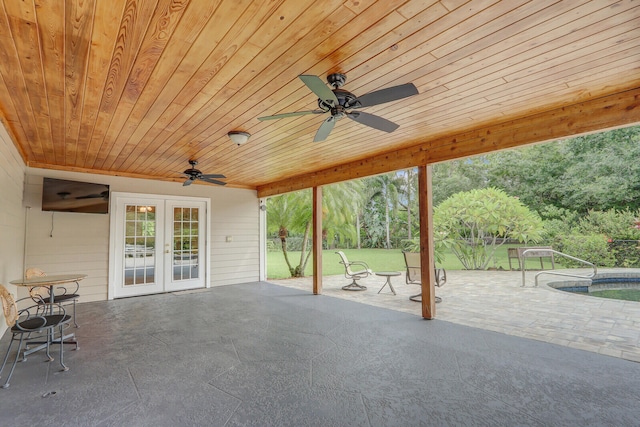 view of patio with a swimming pool, french doors, and ceiling fan