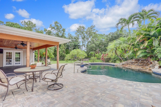 view of pool with a patio area, ceiling fan, and french doors