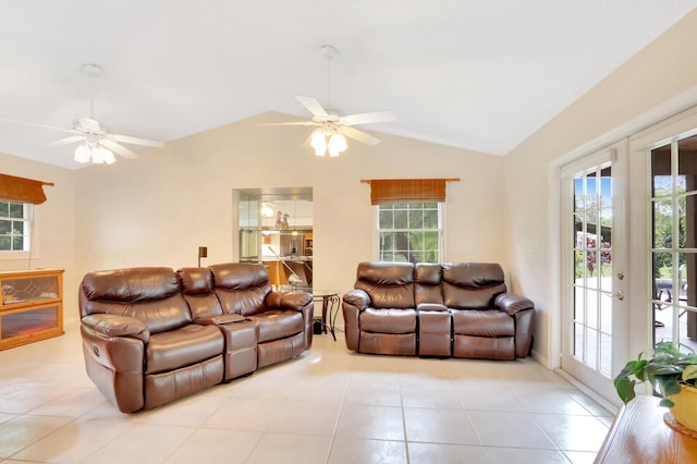 tiled living room featuring a wealth of natural light, lofted ceiling, ceiling fan, and french doors