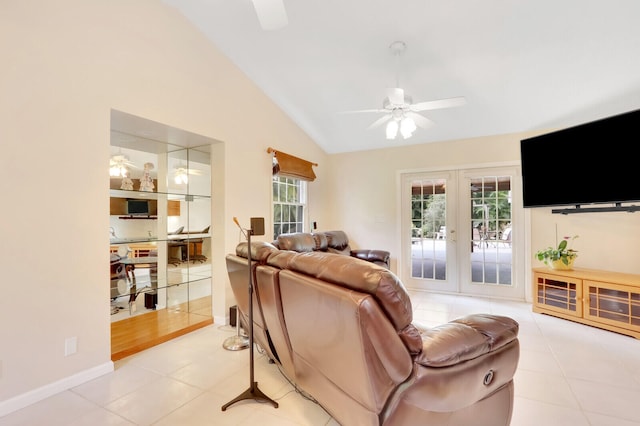 tiled living room with french doors, ceiling fan, and vaulted ceiling