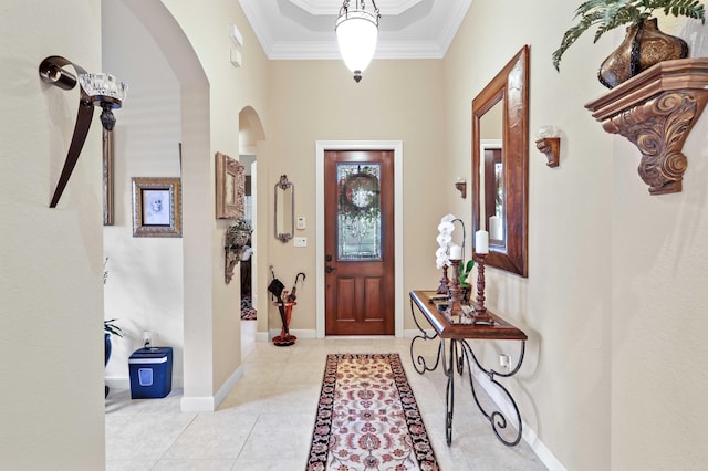 tiled entrance foyer featuring ornamental molding