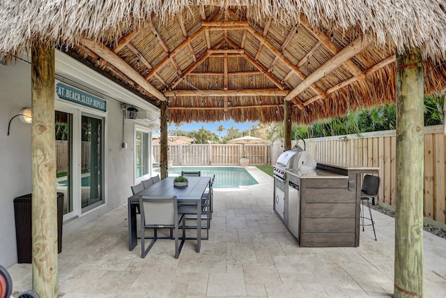 view of patio / terrace with a gazebo, grilling area, french doors, and a fenced in pool