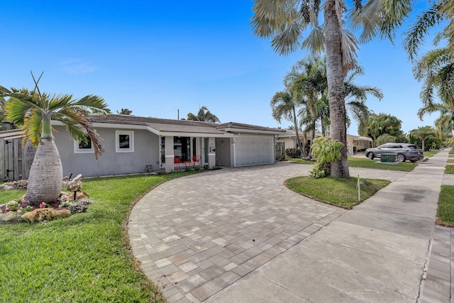 ranch-style house with a garage and a front yard