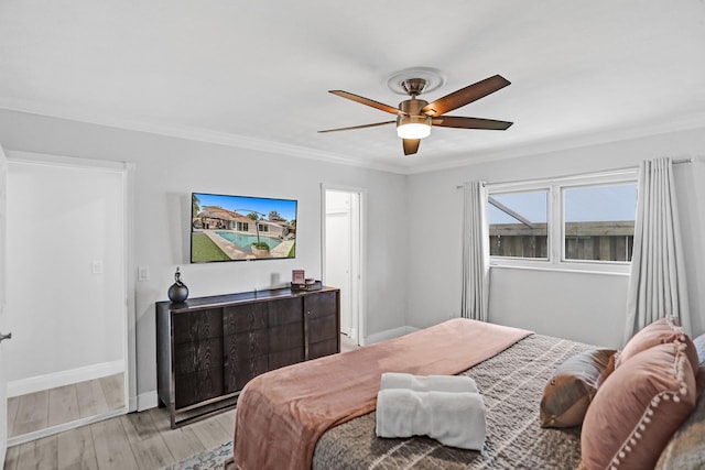 bedroom featuring ornamental molding, ceiling fan, and light wood-type flooring