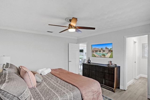 bedroom with crown molding, light hardwood / wood-style flooring, and ceiling fan