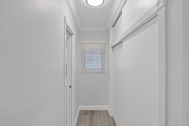 corridor with wood-type flooring and crown molding