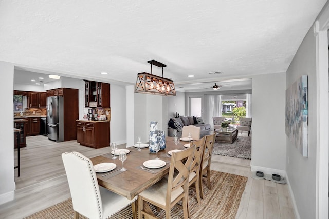 dining room with light hardwood / wood-style flooring and ceiling fan