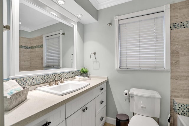 bathroom featuring tasteful backsplash, toilet, vanity, and ornamental molding