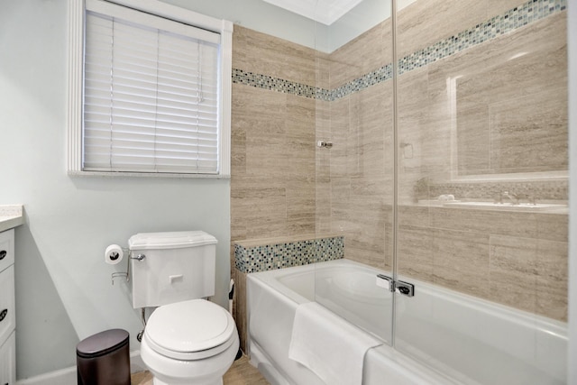 full bathroom featuring vanity, tiled shower / bath, and toilet