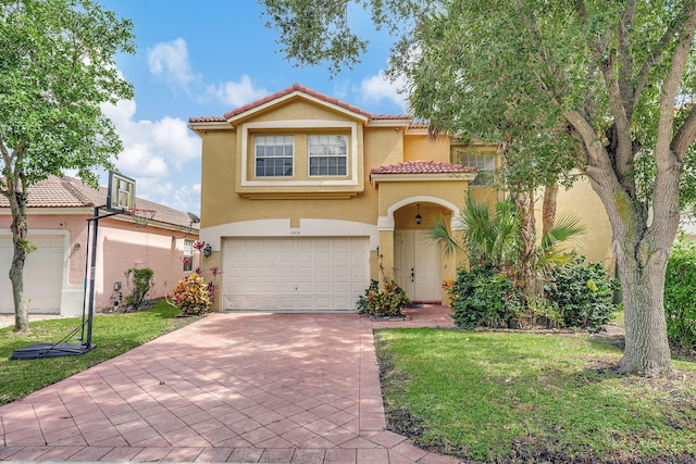 mediterranean / spanish-style house featuring a garage and a front yard