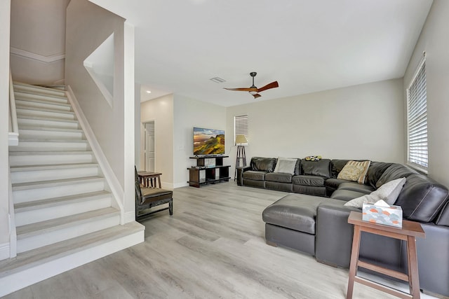 living room featuring ceiling fan and light hardwood / wood-style floors