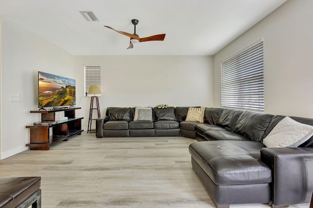 living room with light wood-type flooring and ceiling fan