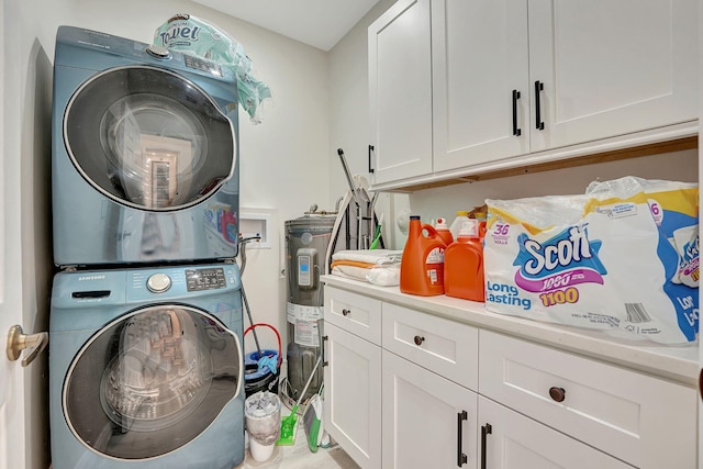 washroom featuring cabinets and stacked washer / drying machine