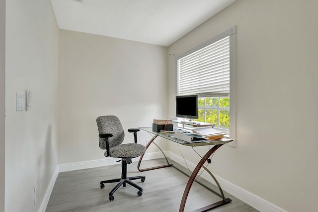 office with light wood-type flooring